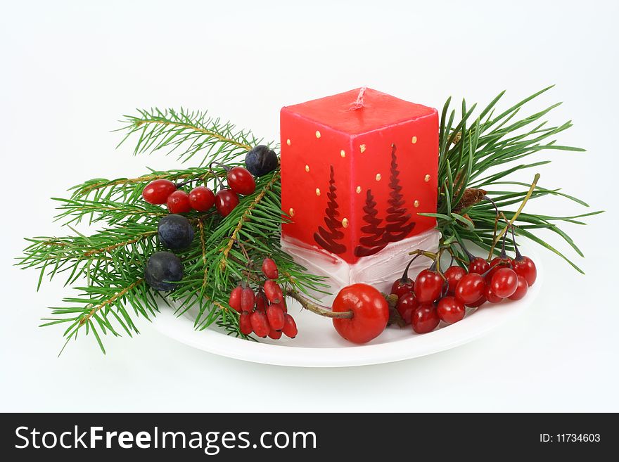 Near to a Christmas candle the fur-tree branch, berries of a dogrose, wild plum,  berries  of a barberry,   berries  woody nightshade is located. Near to a Christmas candle the fur-tree branch, berries of a dogrose, wild plum,  berries  of a barberry,   berries  woody nightshade is located.
