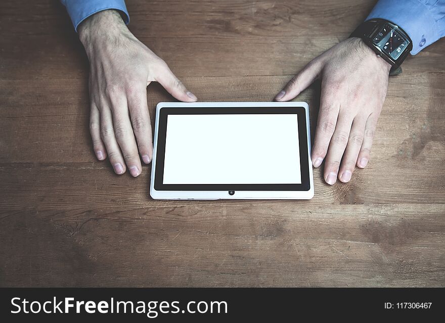 Hands Using Tablet White Screen Display On Wooden Desk.