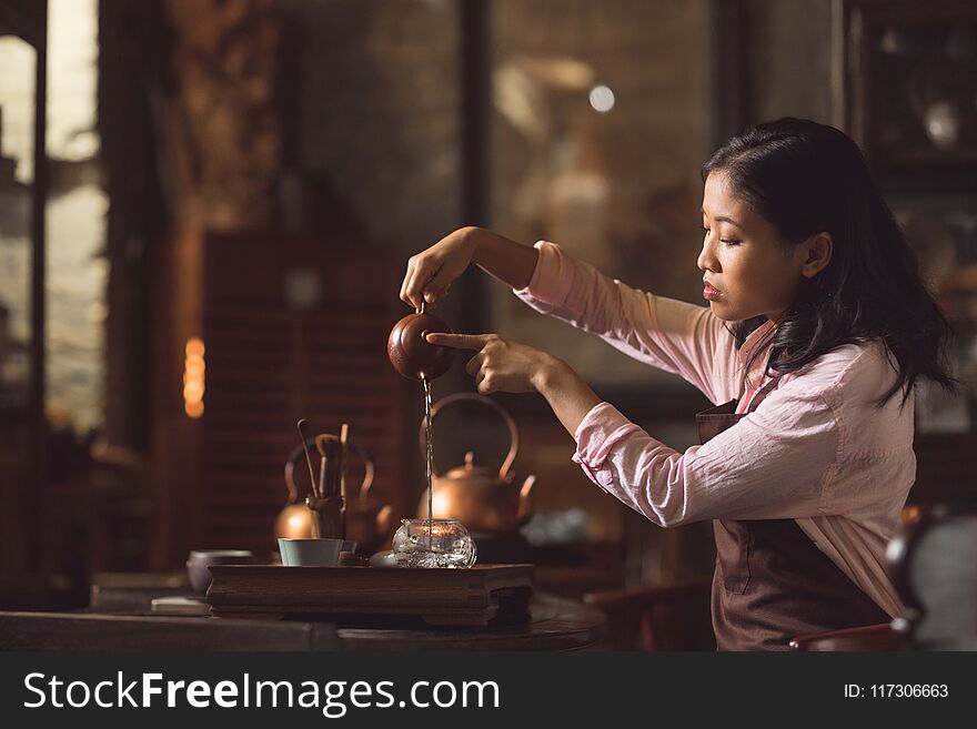 Young girl pouring tea