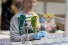 Unrecognizable Young Saleswoman And Two Empty Bright Wafer Sweet Cornets For Ice Cream, Waffle Cones. Selective Focus Royalty Free Stock Photography Unrecognizable Young Saleswoman And Two Empty Bright Wafer Sweet Cornets For Ice Cream, Waffle Cones. Selective Focus Royalty Free Stock Photography