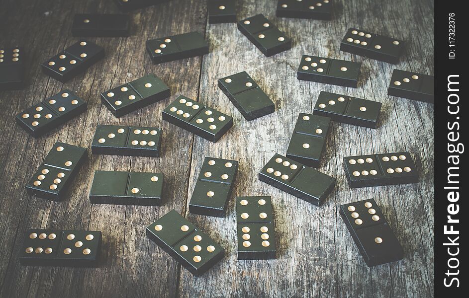 Domino Pieces On The Brown Wooden Table