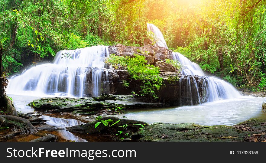 Jungle landscape with wonderful waterfall at deep tropical rain forest, vacation and relaxation concept