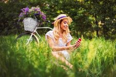 Beautiful Young Girl With Vintage Bicycle And Flowers On City Background In The Sunlight Outdoor. Royalty Free Stock Image Beautiful Young Girl With Vintage Bicycle And Flowers On City Background In The Sunlight Outdoor. Royalty Free Stock Image