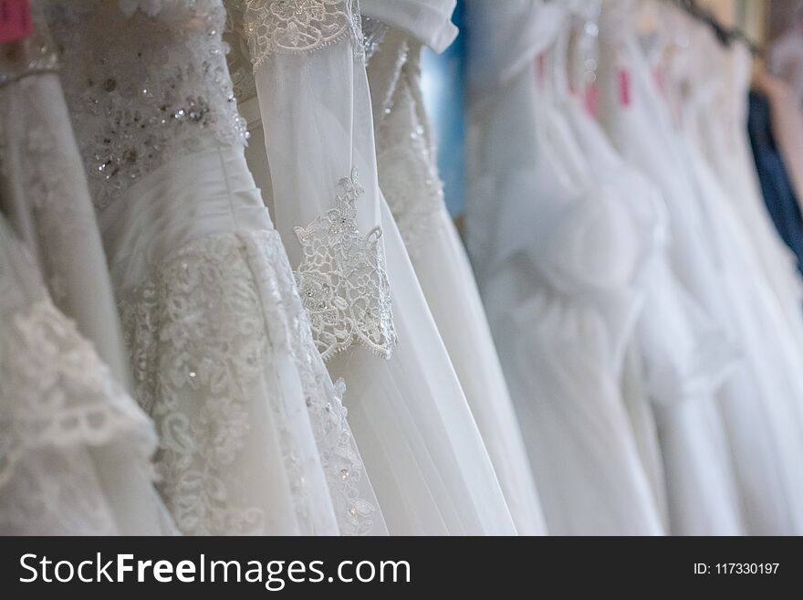 White wedding dresses hanging on racks,Thailand