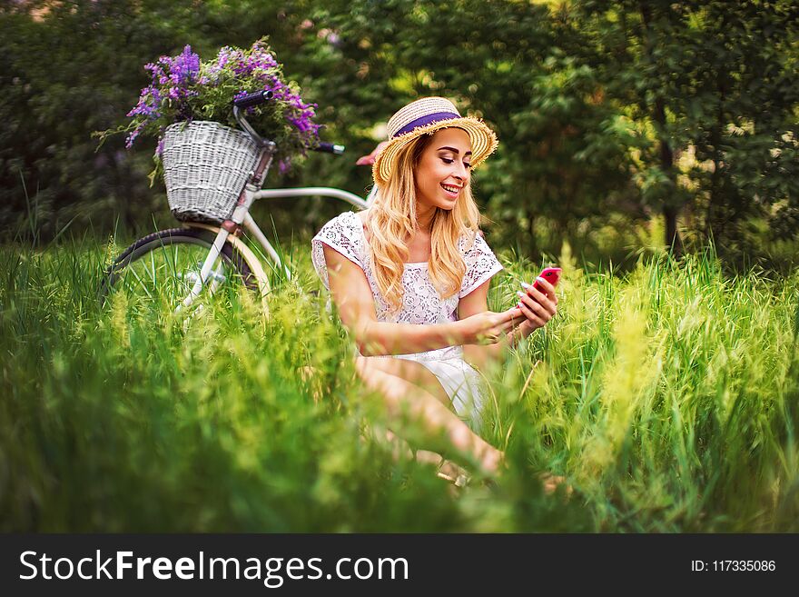 Beautiful Young Girl With Vintage Bicycle And Flowers On City Background In The Sunlight Outdoor.