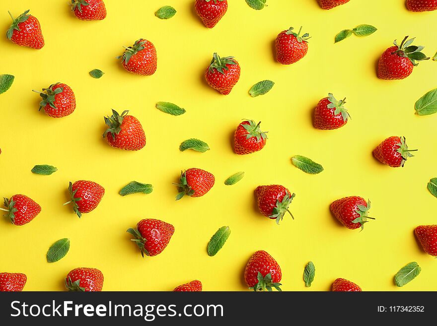 Flat lay composition with with tasty ripe strawberries and mint on color background