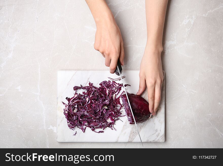 Woman cutting red cabbage