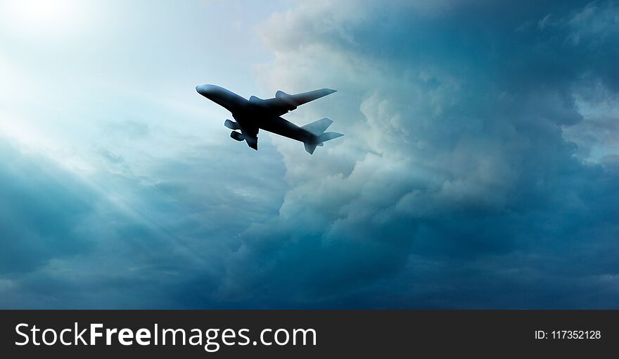 Airplane in dark blue sky with cloudy in sunrise background