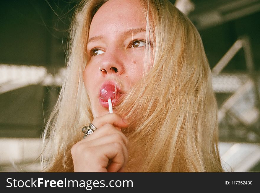 Woman Licking Lollipop