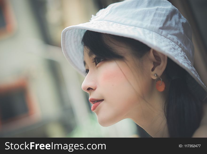 Selective Focus Photo of Woman Wearing White Cap