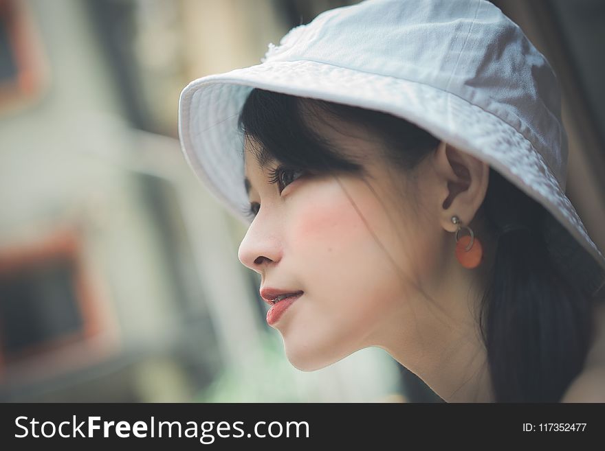 Selective Focus Photo Of Woman Wearing White Cap