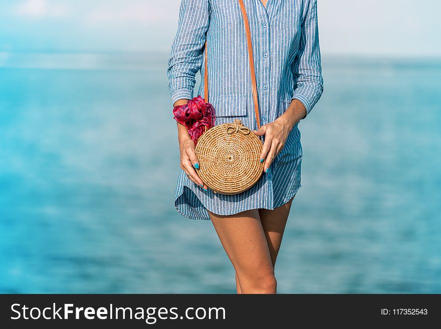 Woman Wearing Blue Long-sleeved Button-up Dress And Brown Sling Bag