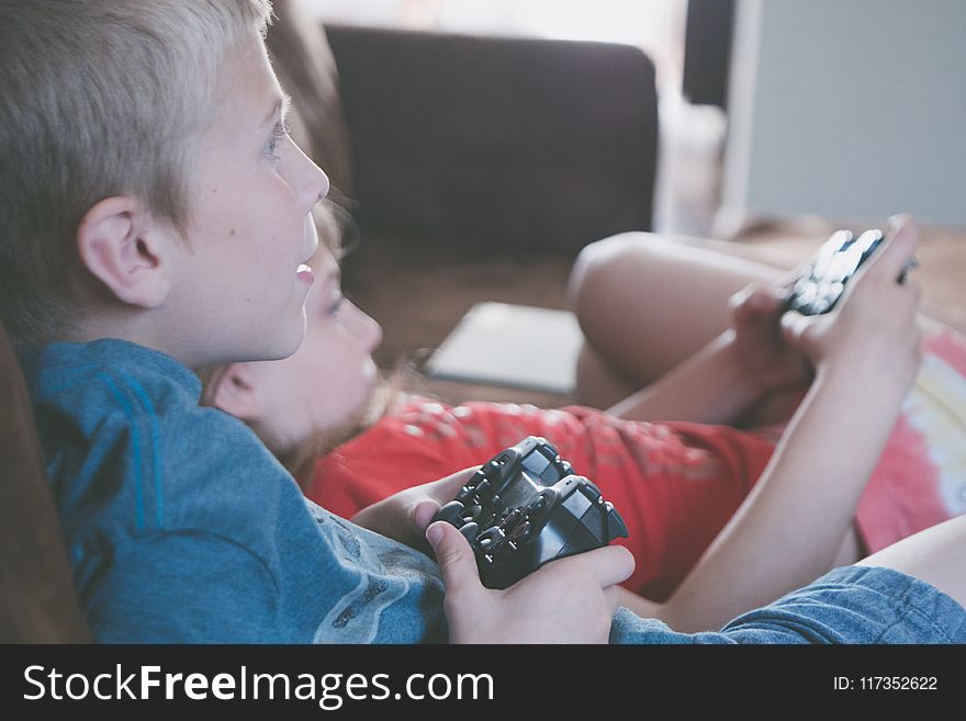 Two Boy and Girl Holding Game Controllers