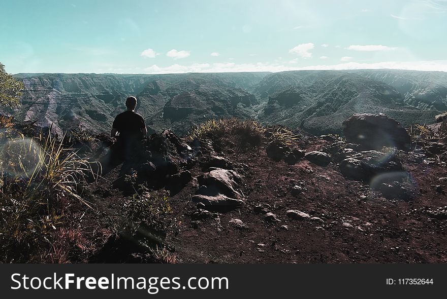 Person Standing Near Cliff