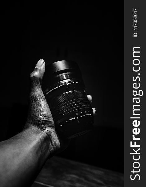 Person Holding Olympus Camera Lens