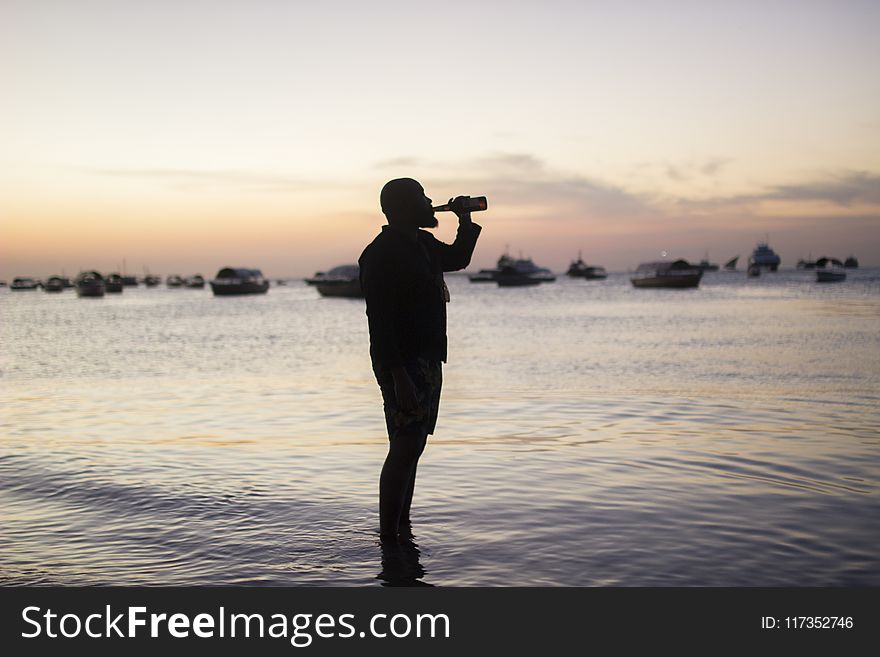 Silhouette Photo Of Man Drinking