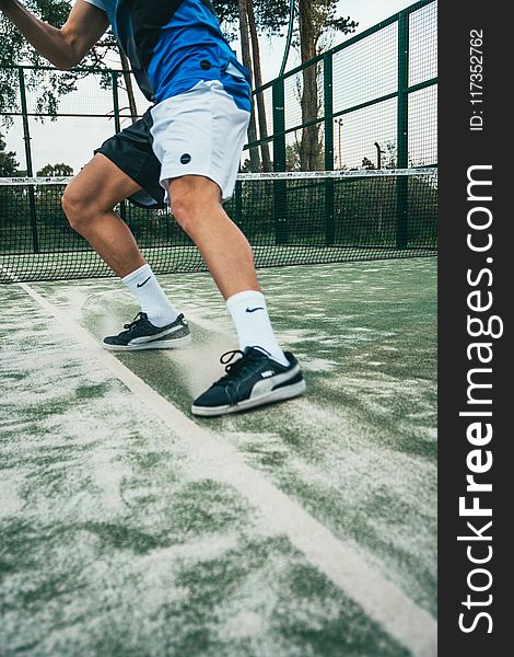 Close-up Photo of Man Standing on Tennis Court