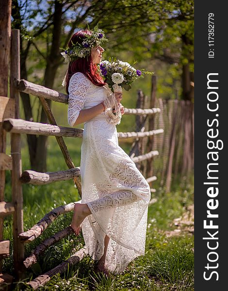 Woman In White Long-sleeved Gown Holding Flower Bouquet