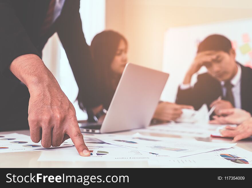 Hands pointing on data chart sheet for business meeting