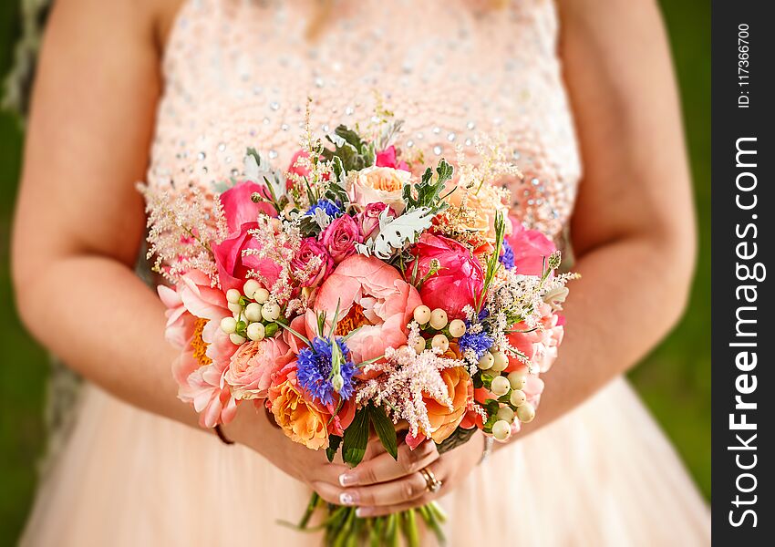 Beauty wedding bouquet in bride`s hands