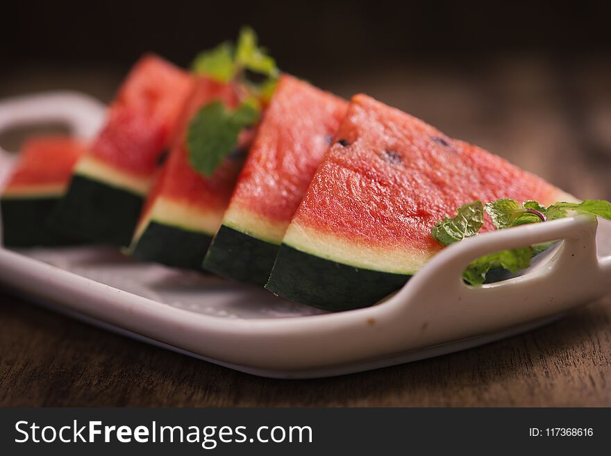 Fresh Sliced Watermelon In White Dish On Wooden Table.