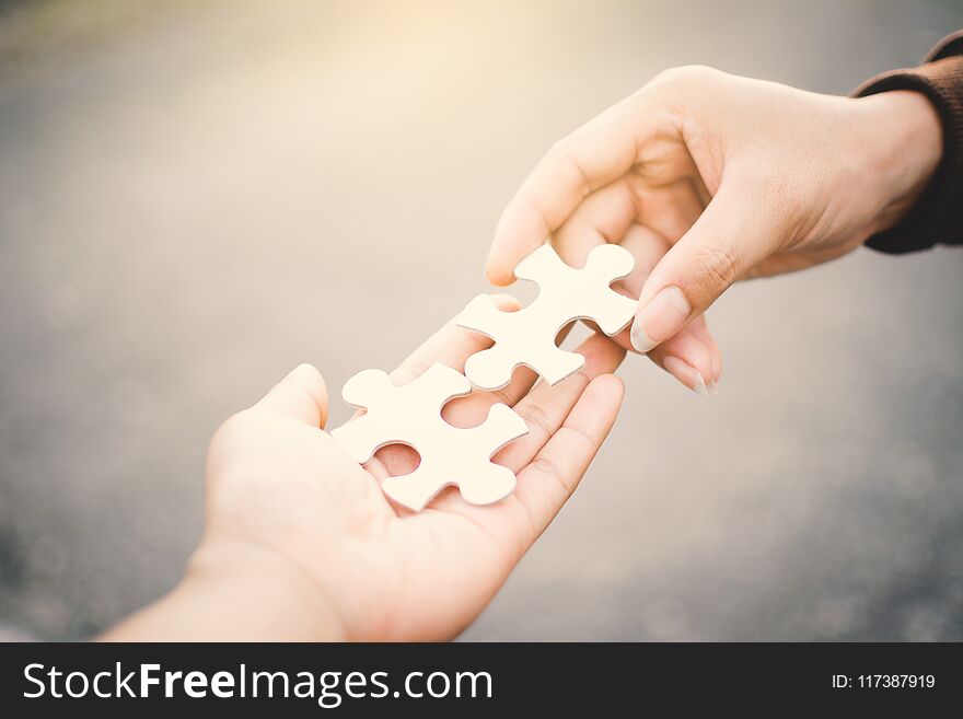 Hand holding jigsaw success concept ,selective and soft