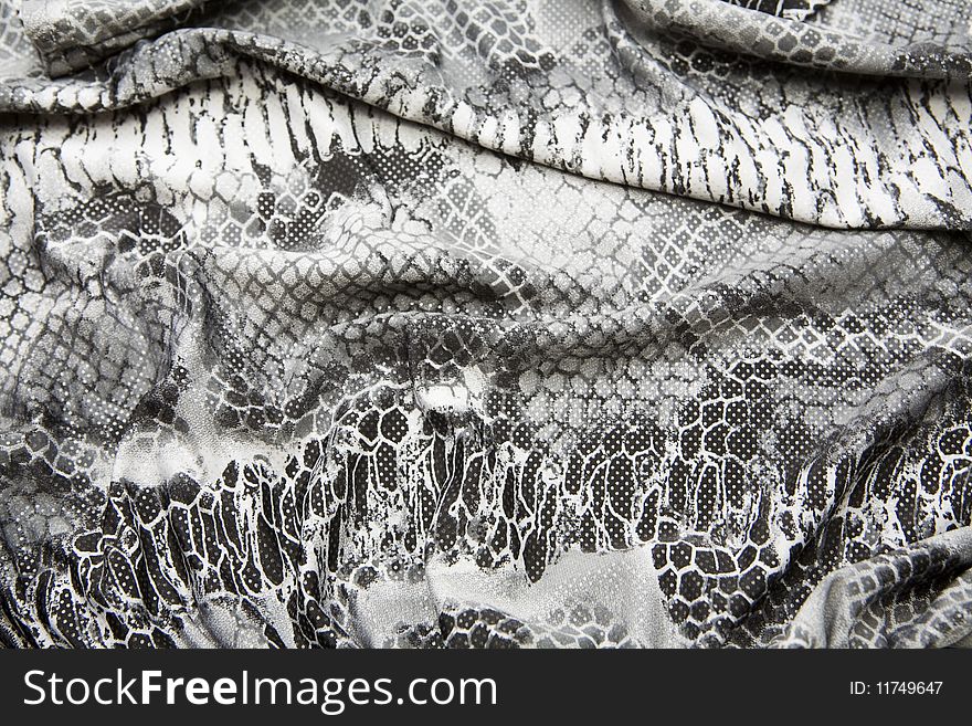 A close up of fabric with black and white snake skin pattern of women cloth. A close up of fabric with black and white snake skin pattern of women cloth