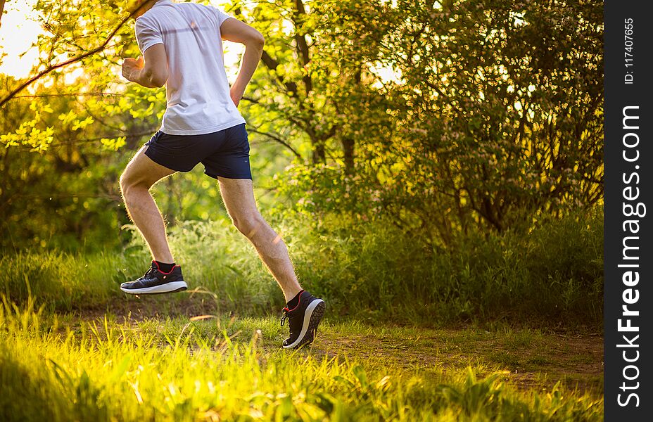 Athletic young man running in nature