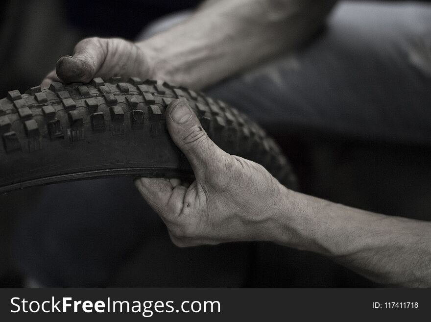 Man& x27;s hand are repairing bicycle& x27;s tire. Man& x27;s hand are repairing bicycle& x27;s tire