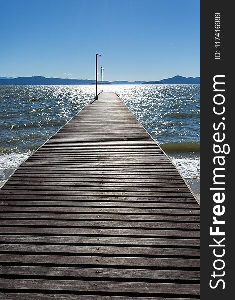 A beautiful image of a pier in a Cacupé Beach in a sunny day