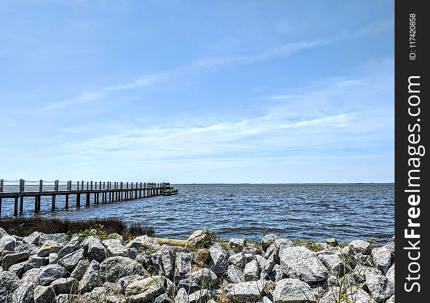 Brown Wooden Dock Near Gray Rocks