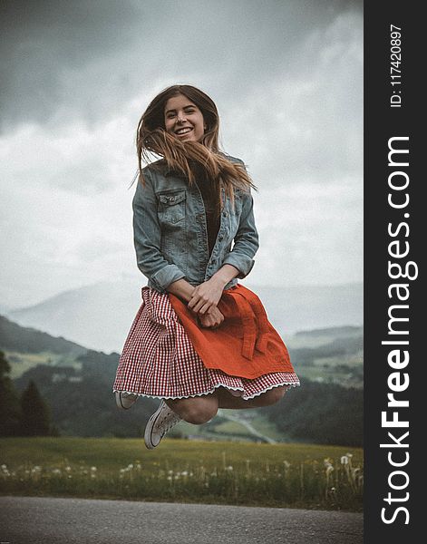 Woman in Blue Denim Jacket Jumping