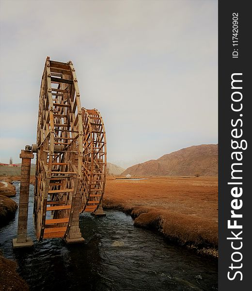 Brown Wooden Wheel On River