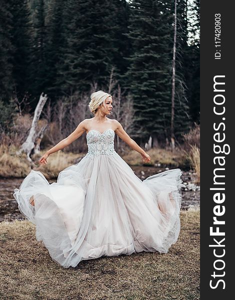 Woman Wearing White Sweetheart-neckline Dress Standing Near Green Leaf Trees