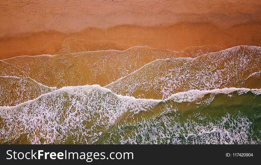 Aerial Photography of Flow of Water Near Sand