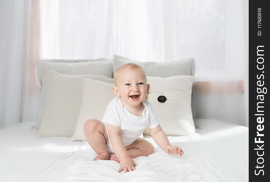 Laughing Baby Wearing White Shirt