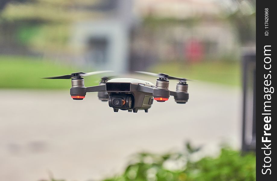 Selective Focus Photo of Flying Gray Quadcopter