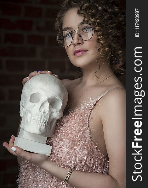 Woman Holding Skull Replica