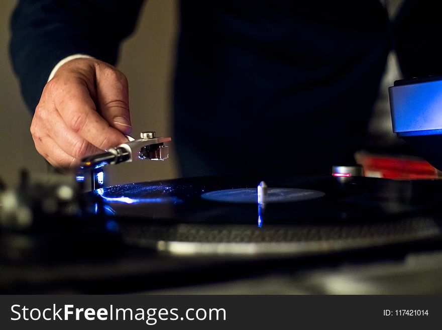 Person Holding Vinyl Player in Shallow Focus Photography