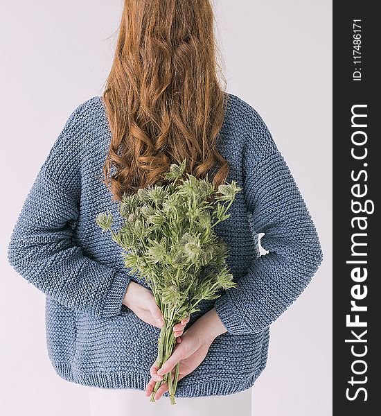 Woman in Gray Sweater Holding Green Leaf Plants