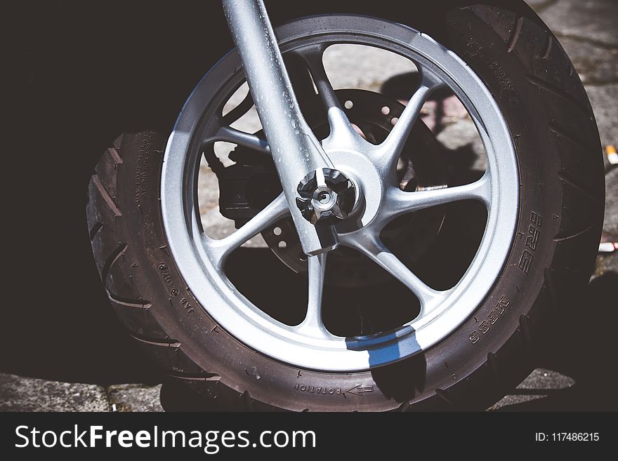 Silver Motorcycle Rim and Tire