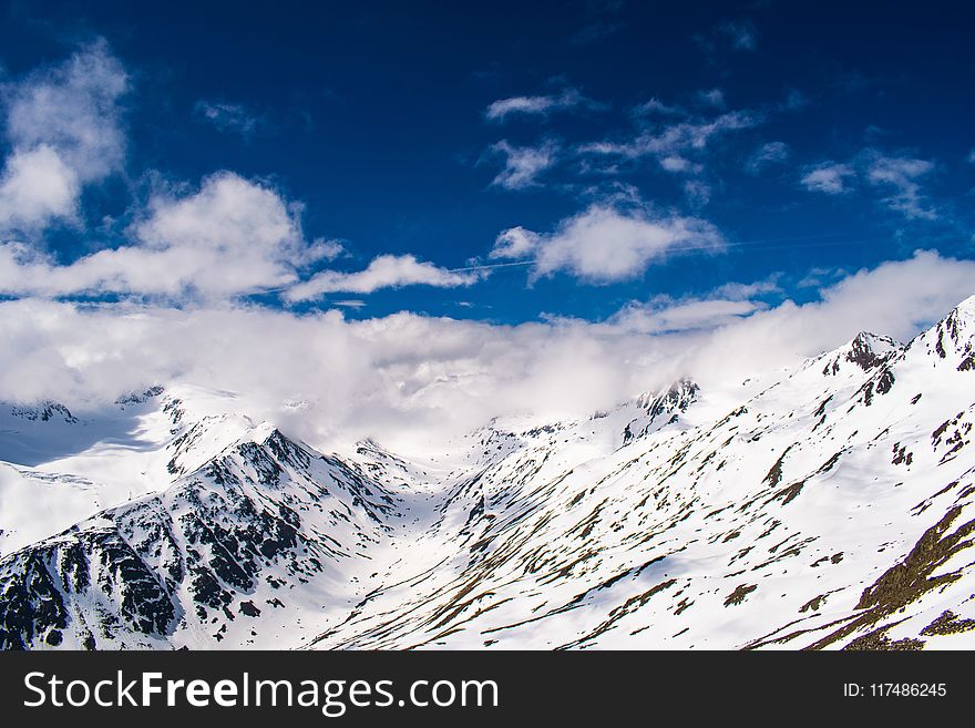 Snowy Mountain With White Clouds