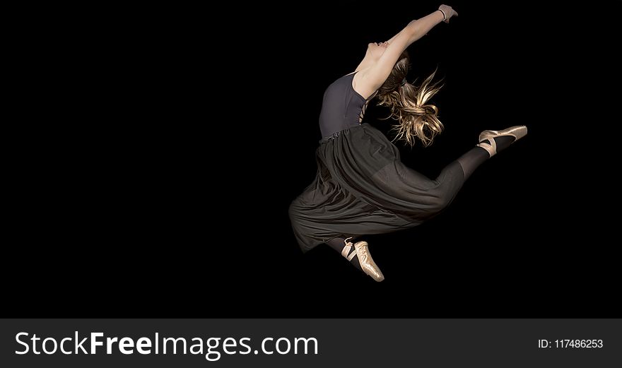 Woman in Black Sleeveless Shirt and Pants Jumping