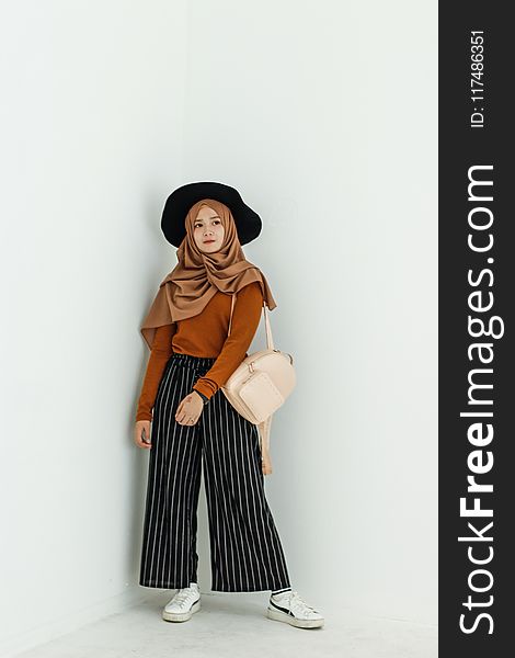 Woman in Brown Long-sleeved Shirt and Brown Hijab Headdress With Beige Leather Backpack