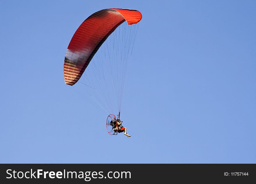 Colorful paraglide on blue sky