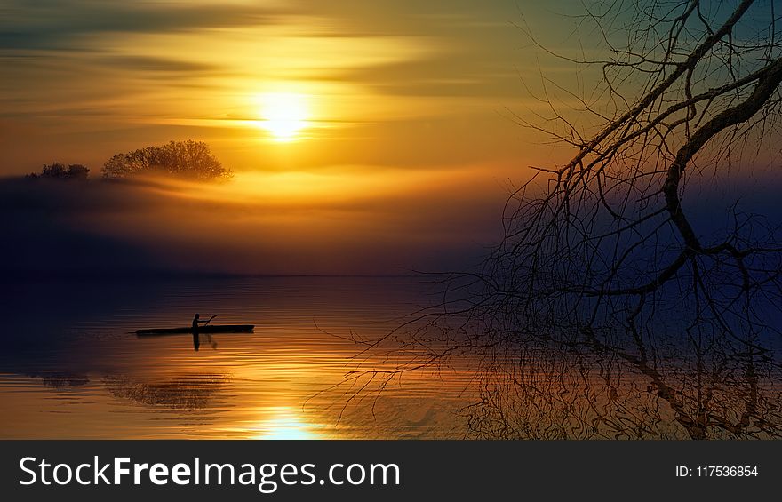 Man Riding Boat During Sunset