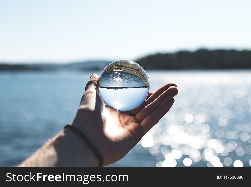 Selective Focus Photography of Person Holding Water Bubble