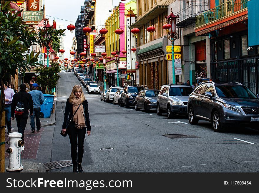 Woman Wearing Black Jacket Walking on the Road