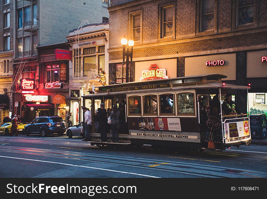 Gray And Black Tram During Night Time