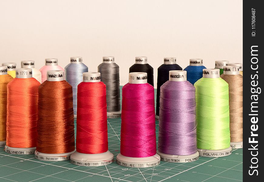 Assorted Sewing Threads on Greensurface